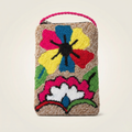 Porta celular artesanal con bordado floral en relieve de colores fucsia, azul y amarillo sobre fondo beige, con asa trenzada rosa.